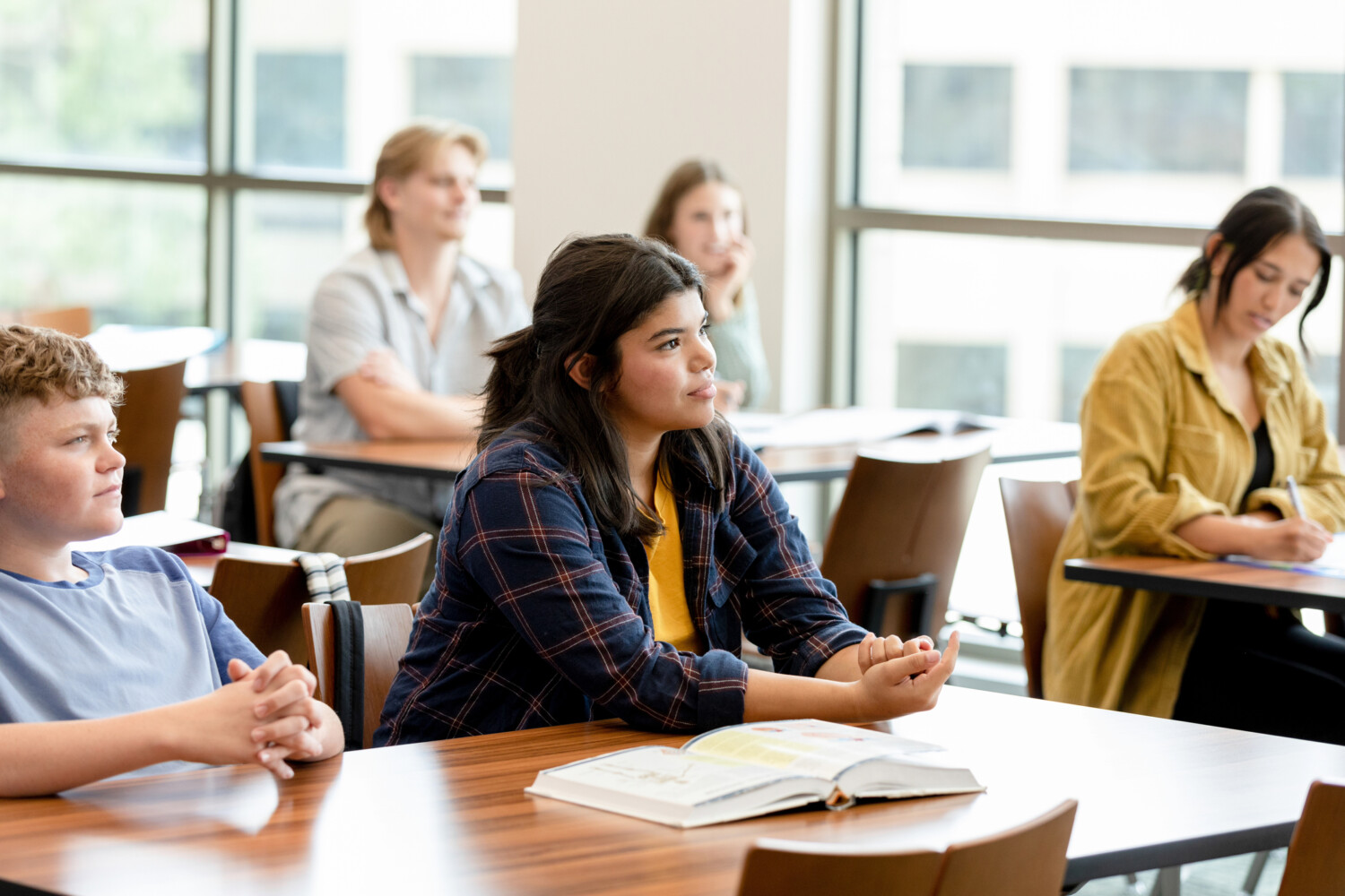 College students take notes as they listen to the professor