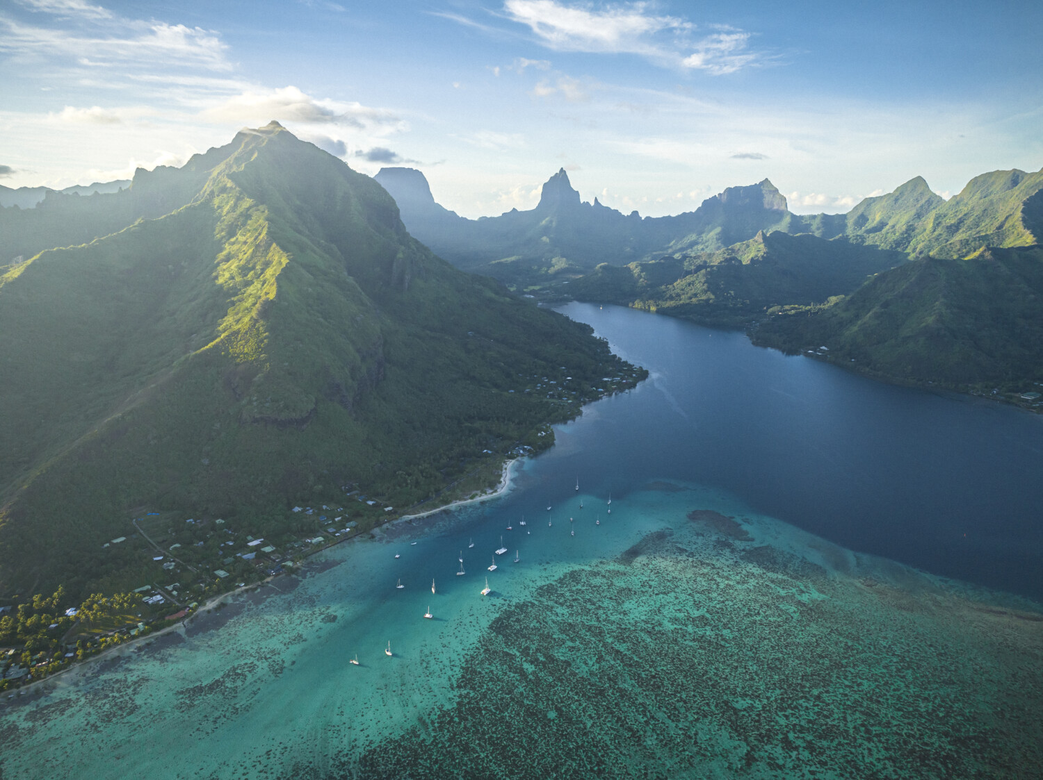 Sailing boats near the Moorea shore in the morning