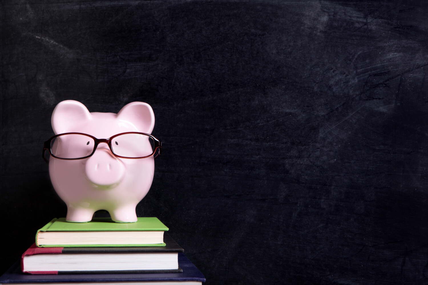 Piggy bank with glasses and blackboard