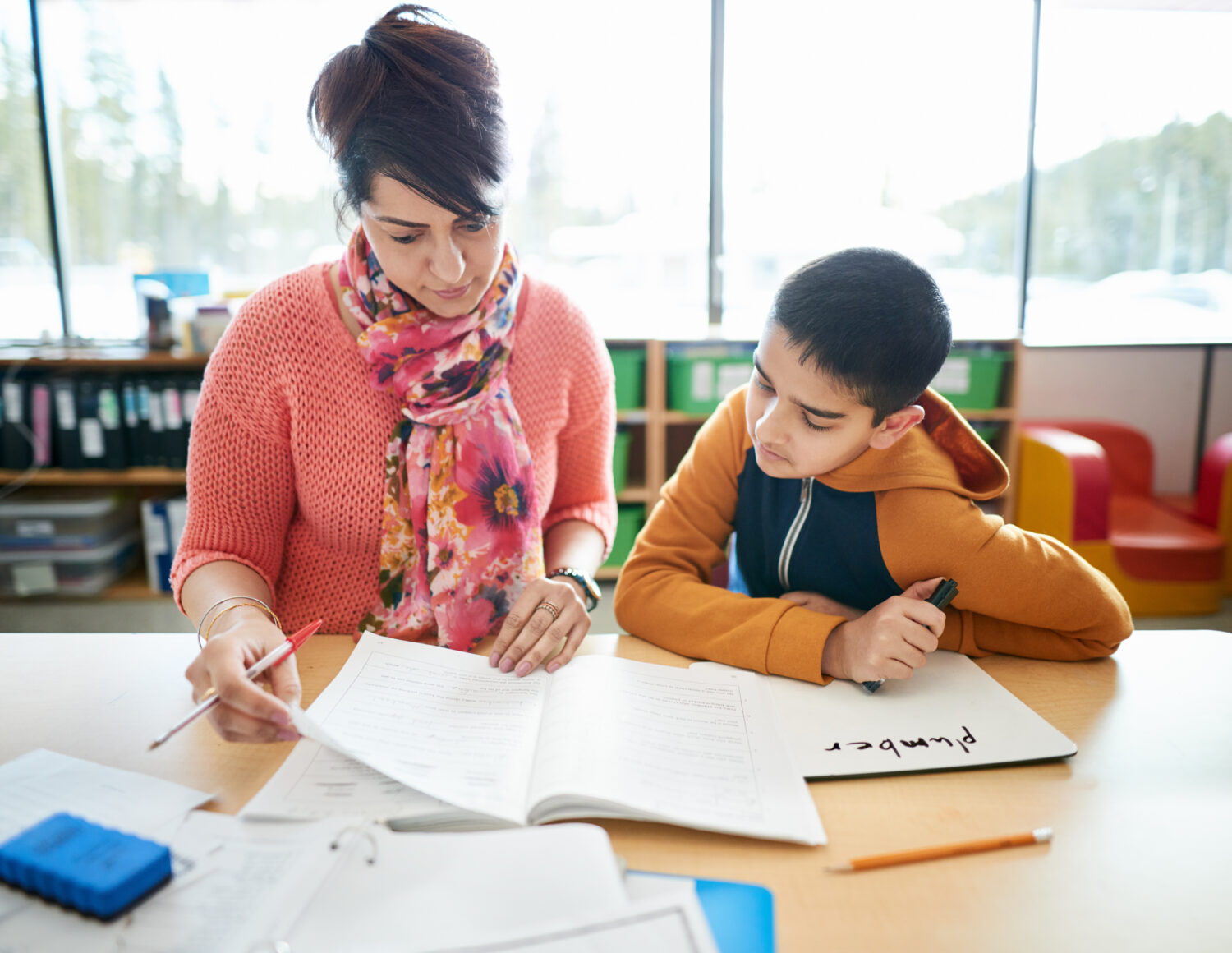 Teacher helping student with studies