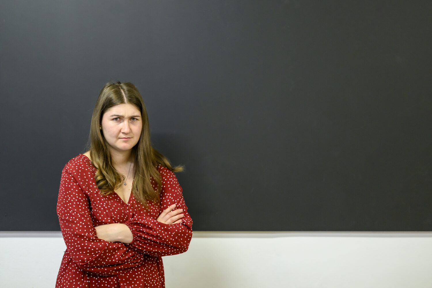 Angry teacher standing at the blackboard