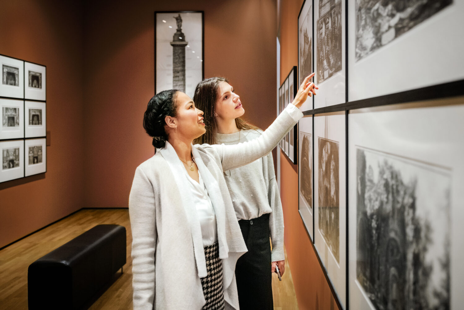 Women discussing art in classy gallery