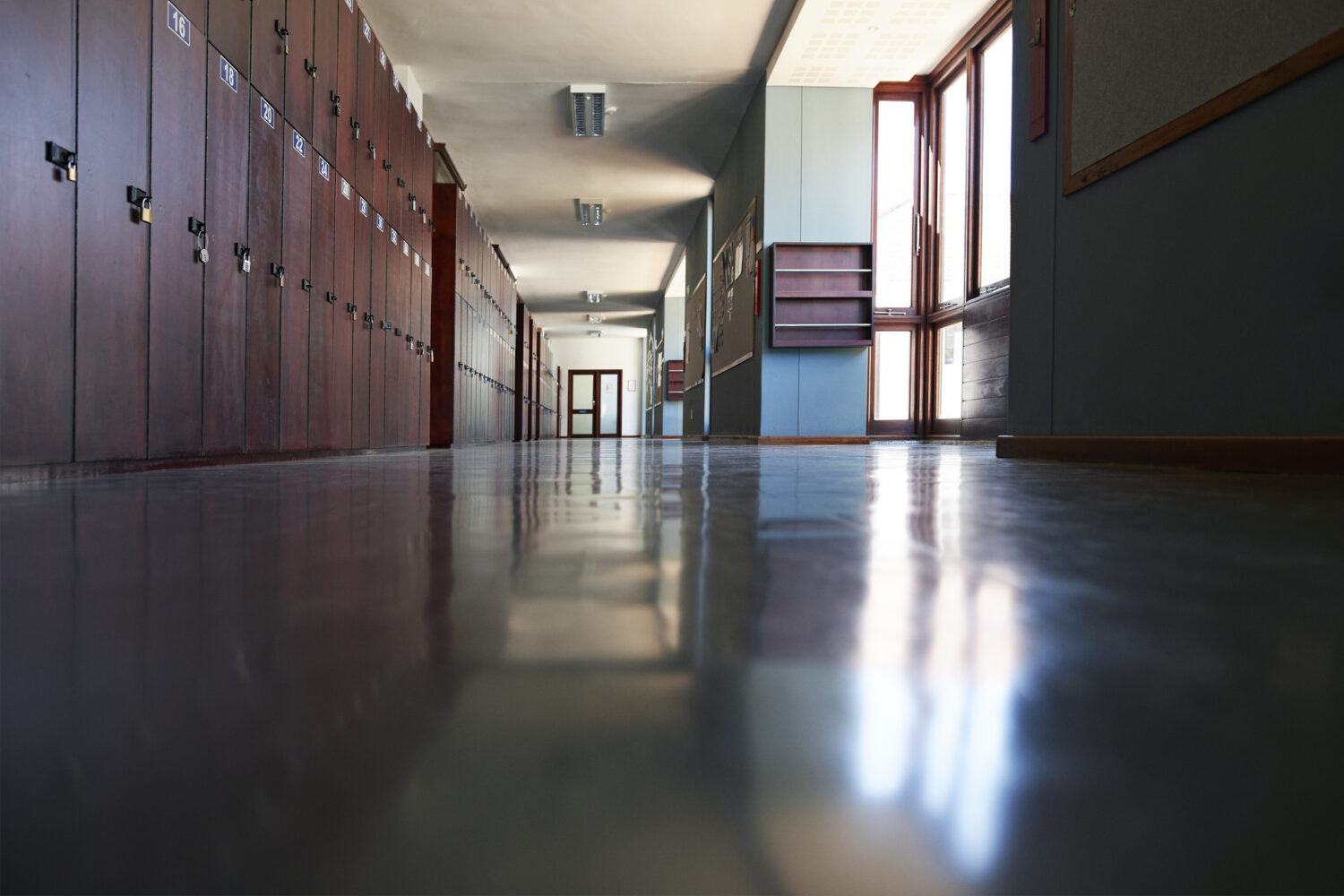 Surface level view of empty corridor with lockers